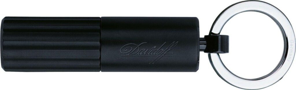 A close up of the sleek matte black Davidoff Black Duo Cut double punch cutter on a key ring
